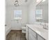 Bright bathroom features a window and vanity with modern fixtures at 507 Bonneset Ct, Canton, GA 30114
