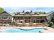 Stunning clubhouse featuring a pool, outdoor seating, and beautiful landscaping for luxurious community living at 507 Bonneset Ct, Canton, GA 30114