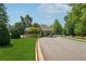 Inviting community entrance with well-maintained landscaping, a guard house, and an American flag at 507 Bonneset Ct, Canton, GA 30114