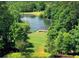 Picturesque pond area with a charming gazebo and amphitheater seating nestled in nature at 507 Bonneset Ct, Canton, GA 30114