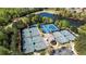 An aerial view featuring multiple tennis courts and a tranquil pond showcasing the community's amenities at 507 Bonneset Ct, Canton, GA 30114