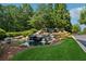 Scenic Soleil community entrance with a rock waterfall feature, lush greenery, and a welcoming atmosphere at 507 Bonneset Ct, Canton, GA 30114