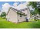 The two-story home has vinyl siding and a lush green backyard at 6207 Idlewood Cir, Lithonia, GA 30038