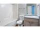 Bathroom featuring a shower-tub combo and a wood-look vanity sink at 6207 Idlewood Cir, Lithonia, GA 30038