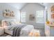 Bright bedroom featuring vaulted ceiling, two windows, and fun decorative shelving at 6207 Idlewood Cir, Lithonia, GA 30038