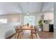 Bright dining area with vaulted ceilings, modern furniture, and stylish decor at 6207 Idlewood Cir, Lithonia, GA 30038