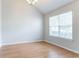 Bright empty room with hardwood floors, neutral paint, and a large window at 6207 Idlewood Cir, Lithonia, GA 30038