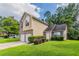 Inviting two-story home featuring a well-manicured front lawn and attached garage at 6207 Idlewood Cir, Lithonia, GA 30038
