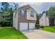 Attractive two-story house showcasing a two-car garage and lush green landscaping at 6207 Idlewood Cir, Lithonia, GA 30038