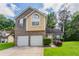 Charming two-story home with a two-car garage and well-maintained lawn at 6207 Idlewood Cir, Lithonia, GA 30038