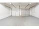 Spacious two-car garage with white doors and a light gray floor at 6207 Idlewood Cir, Lithonia, GA 30038
