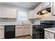 Charming kitchen features black appliances, light wood cabinets, and granite-look countertops at 6207 Idlewood Cir, Lithonia, GA 30038