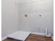 The laundry room has hardwood floors and white walls at 6207 Idlewood Cir, Lithonia, GA 30038