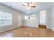 Bright living room boasts hardwood floors, ceiling fan, and open layout to the kitchen at 6207 Idlewood Cir, Lithonia, GA 30038