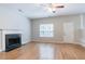Cozy living room features a fireplace, hardwood floors, and a window overlooking the lawn at 6207 Idlewood Cir, Lithonia, GA 30038
