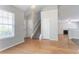 Inviting living room features hardwood floors, a staircase, and natural light from a window at 6207 Idlewood Cir, Lithonia, GA 30038