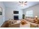 Cozy living room featuring a fireplace, plush seating, and hardwood floors at 6207 Idlewood Cir, Lithonia, GA 30038