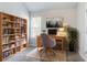 Comfortable home office with built-in shelving, a work desk, and ample lighting at 6207 Idlewood Cir, Lithonia, GA 30038