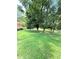 A lush green backyard features mature trees, providing shade and a serene atmosphere for outdoor activities at 1098 Laurel Nw Ln, Conyers, GA 30012