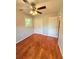 Bedroom with hardwood floors, a ceiling fan, a double closet, and a window at 1098 Laurel Nw Ln, Conyers, GA 30012