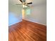 This bedroom has hardwood floors, a ceiling fan, and a window at 1098 Laurel Nw Ln, Conyers, GA 30012