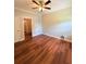 This bedroom has hardwood floors, a ceiling fan, and a window at 1098 Laurel Nw Ln, Conyers, GA 30012