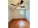This bedroom has hardwood floors, a ceiling fan, a window and a double closet at 1098 Laurel Nw Ln, Conyers, GA 30012