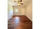 Bedroom featuring hardwood floors, ceiling fan, and window at 1098 Laurel Nw Ln, Conyers, GA 30012