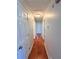 Hallway with wood floors and white doors at 1098 Laurel Nw Ln, Conyers, GA 30012