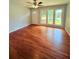 Living room featuring hardwood floors, ceiling fan and door to front yard at 1098 Laurel Nw Ln, Conyers, GA 30012