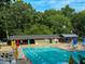 Community pool featuring lounge chairs, umbrellas, and a pool house at 1280 Sanden Ferry Dr, Decatur, GA 30033
