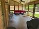 Screened porch featuring comfortable seating, ceiling fan, and stamped concrete flooring at 1280 Sanden Ferry Dr, Decatur, GA 30033