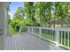 Spacious deck with white railing offering a private outdoor living space surrounded by mature trees at 1420 Fieldgreen Overlook, Stone Mountain, GA 30088