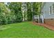 Expansive backyard featuring lush green lawn and mature trees, offering a serene outdoor retreat at 1420 Fieldgreen Overlook, Stone Mountain, GA 30088