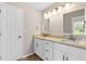 Bright bathroom features double sink vanity with granite countertops and modern lighting at 1420 Fieldgreen Overlook, Stone Mountain, GA 30088