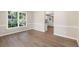 Open dining room showcasing hardwood floors, neutral paint, white trim, and large windows at 1420 Fieldgreen Overlook, Stone Mountain, GA 30088