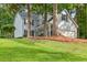 Traditional two-story home with light blue siding, black shutters, and a well-manicured lawn at 1420 Fieldgreen Overlook, Stone Mountain, GA 30088