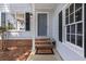 Inviting front porch with brick steps, black door, sidelight windows, and 'Welcome' mat at 1420 Fieldgreen Overlook, Stone Mountain, GA 30088