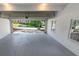 Clean garage interior with gray floor, white walls, and view of the driveway at 1420 Fieldgreen Overlook, Stone Mountain, GA 30088
