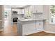 Modern kitchen with white cabinets, granite countertops, stainless steel appliances, and hardwood floors at 1420 Fieldgreen Overlook, Stone Mountain, GA 30088