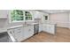 Modern kitchen features granite countertops, stainless steel appliances, and bright white cabinets at 1420 Fieldgreen Overlook, Stone Mountain, GA 30088