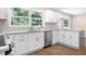 Modern kitchen features granite countertops, stainless steel appliances, and bright white cabinets at 1420 Fieldgreen Overlook, Stone Mountain, GA 30088