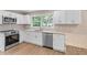 Modern kitchen features granite countertops, stainless steel appliances, and bright white cabinets at 1420 Fieldgreen Overlook, Stone Mountain, GA 30088