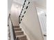 Carpeted staircase features dark wood and white trim at 1420 Fieldgreen Overlook, Stone Mountain, GA 30088