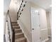 Carpeted staircase features dark wood and white trim at 1420 Fieldgreen Overlook, Stone Mountain, GA 30088
