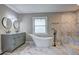 Bathroom showcases dual sinks, a modern tub and a tiled shower at 1675 Bouldercliff Se Ct, Atlanta, GA 30316