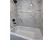Bathroom with white marble tiled walls and a bathtub at 1675 Bouldercliff Se Ct, Atlanta, GA 30316