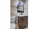 Bathroom boasts a modern vanity, square mirror, and black hardware at 1675 Bouldercliff Se Ct, Atlanta, GA 30316