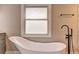 Close up of bathroom featuring a soaking tub and matte black fixtures at 1675 Bouldercliff Se Ct, Atlanta, GA 30316