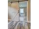 Bathroom featuring wood floors, a barn door and a soaking tub at 1675 Bouldercliff Se Ct, Atlanta, GA 30316